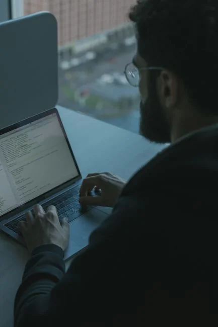 Team members discussing digital graphs on a tablet in a modern office setting.